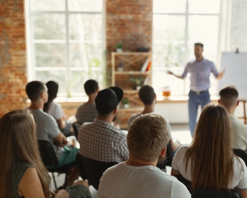 A group of professionals attend a business workshop presentation, representing Veterans Florida entrepreneur networking events and workshops for veteran-owned businesses in Florida.