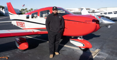 Ovidio Gonzalez in front of a Piper Archer DX Aircraft